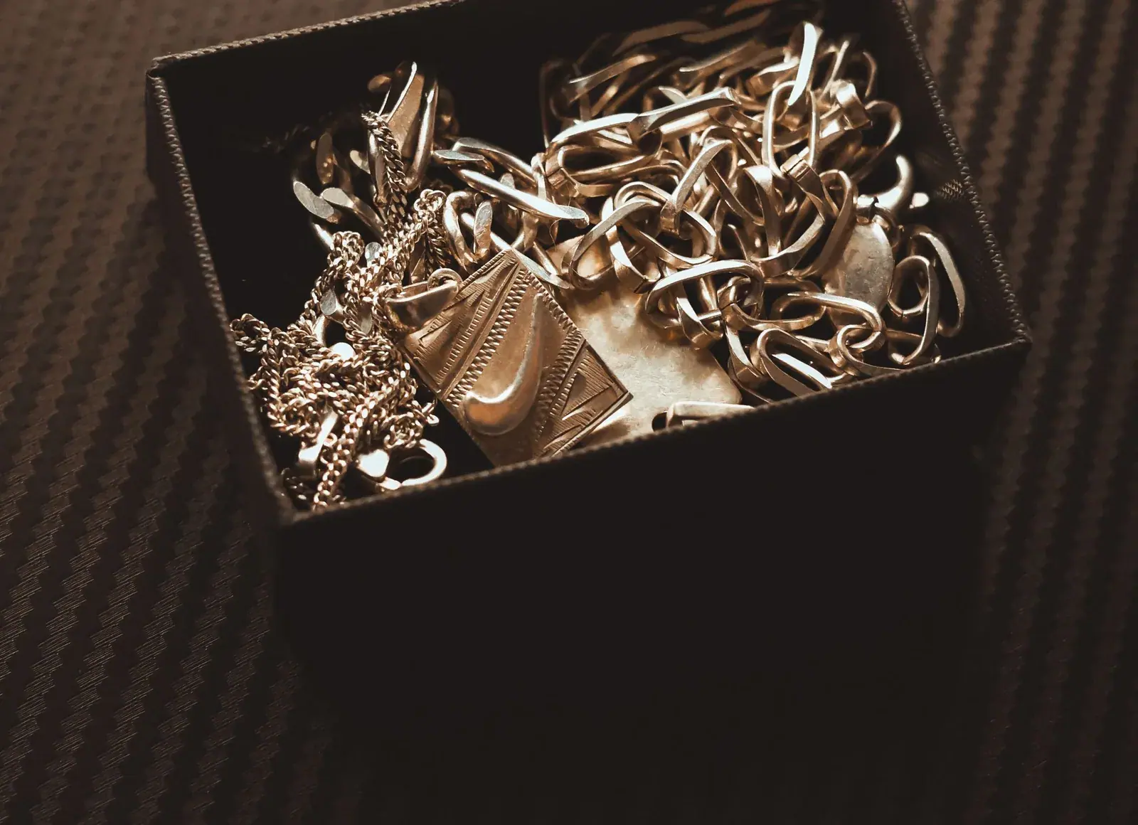 Gold jewellery resting in a keepsake box